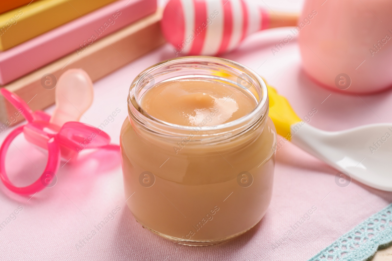 Photo of Healthy baby food in jar on table, closeup