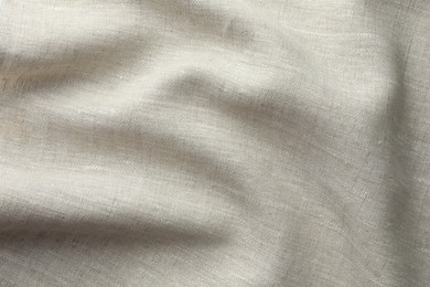 Photo of Texture of beige crumpled fabric as background, top view