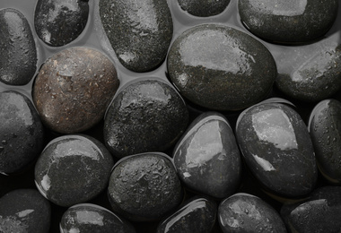 Photo of Spa stones in water as background, top view. Zen lifestyle