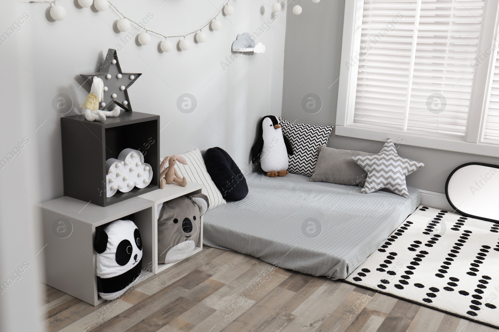 Photo of Montessori bedroom interior with floor bed and toys