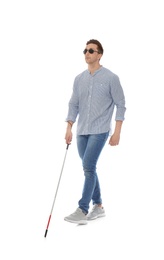 Photo of Young blind person with long cane walking on white background