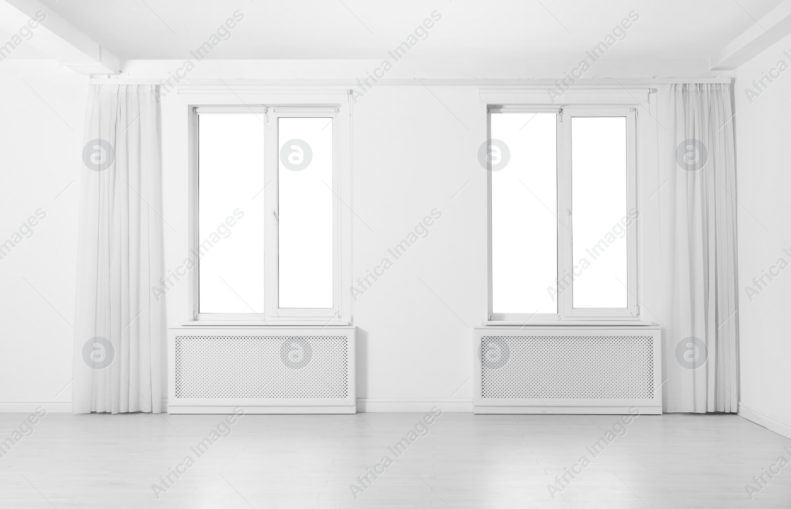 Photo of Windows with elegant curtains in empty room