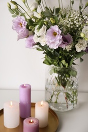 Photo of Bouquet of beautiful Eustoma flowers on white table