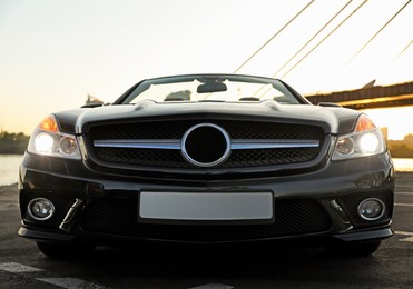 Luxury black convertible car outdoors on city street