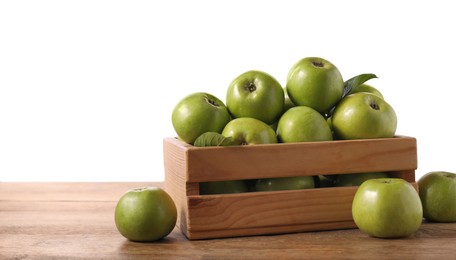 Ripe green apples in crate on wooden table against white background. Space for text