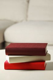 Photo of Many different books stacked on white table indoors, space for text