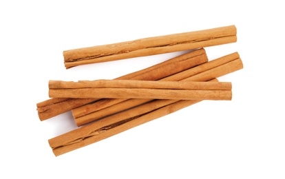 Aromatic dry cinnamon sticks on white background, top view