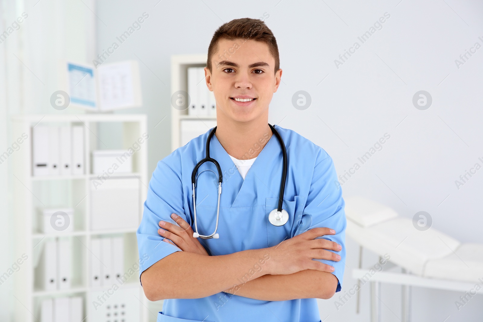 Photo of Young medical assistant with stethoscope in clinic