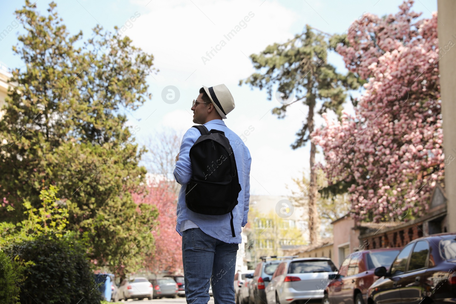 Photo of Tourist with backpack walking on city street