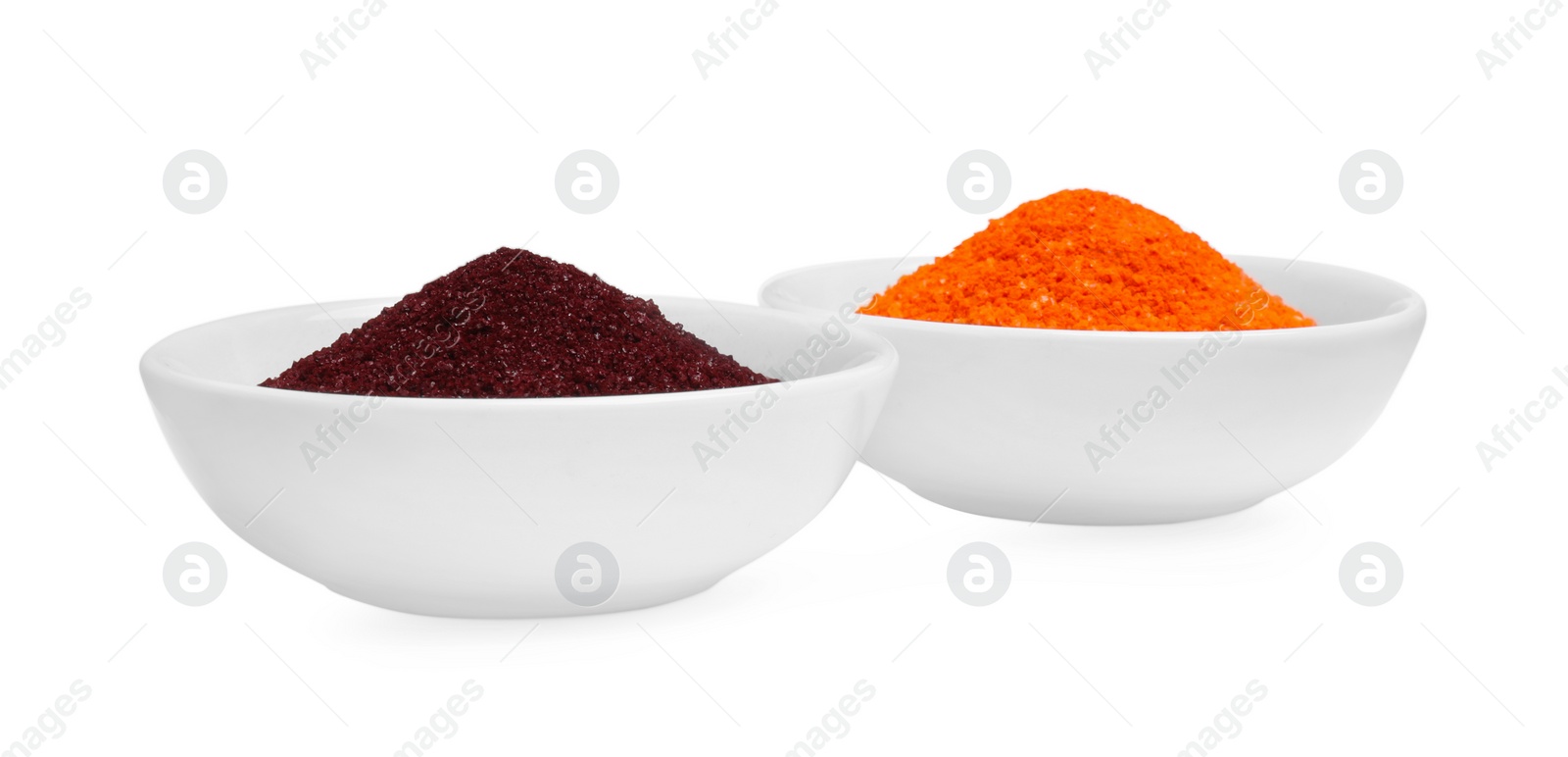 Photo of Bowls with food coloring on white background