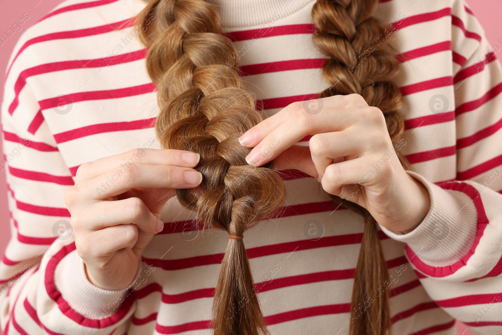 Photo of Young woman with braided hair, closeup view