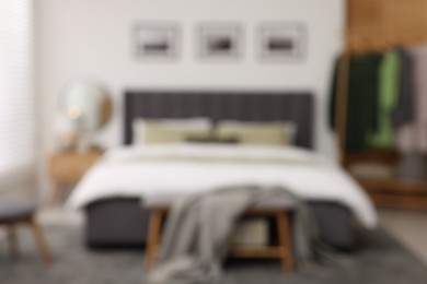 Blurred view of room with comfortable bed