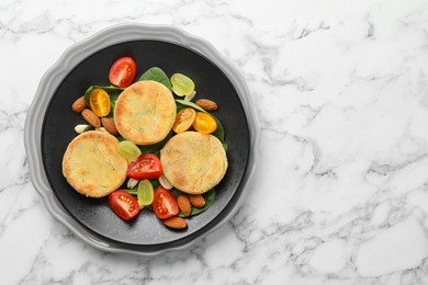 Plate with healthy dish high in vegetable fats on white marble table, top view. Space for text