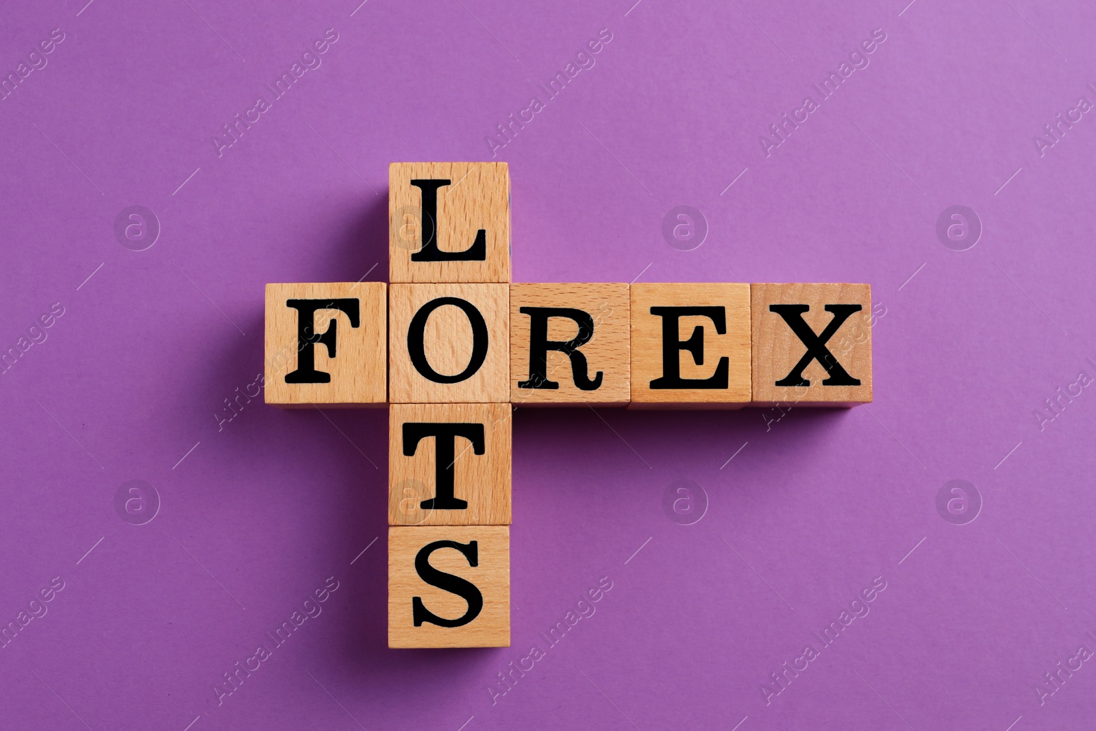 Photo of Forex lots. Wooden cubes placed as crossword on purple background, top view