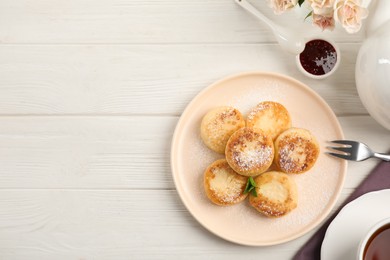 Photo of Delicious cottage cheese pancakes with icing sugar on white wooden table, flat lay. Space for text