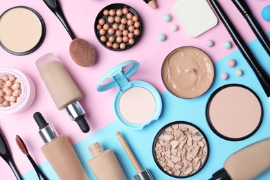 Flat lay composition with skin foundation, powder and beauty accessories on color background