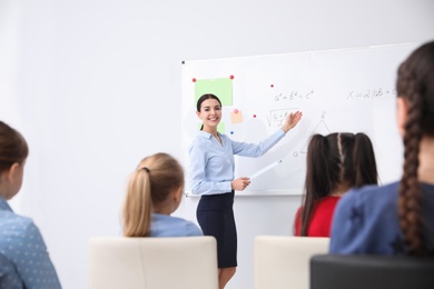 Photo of Young teacher and students in modern classroom