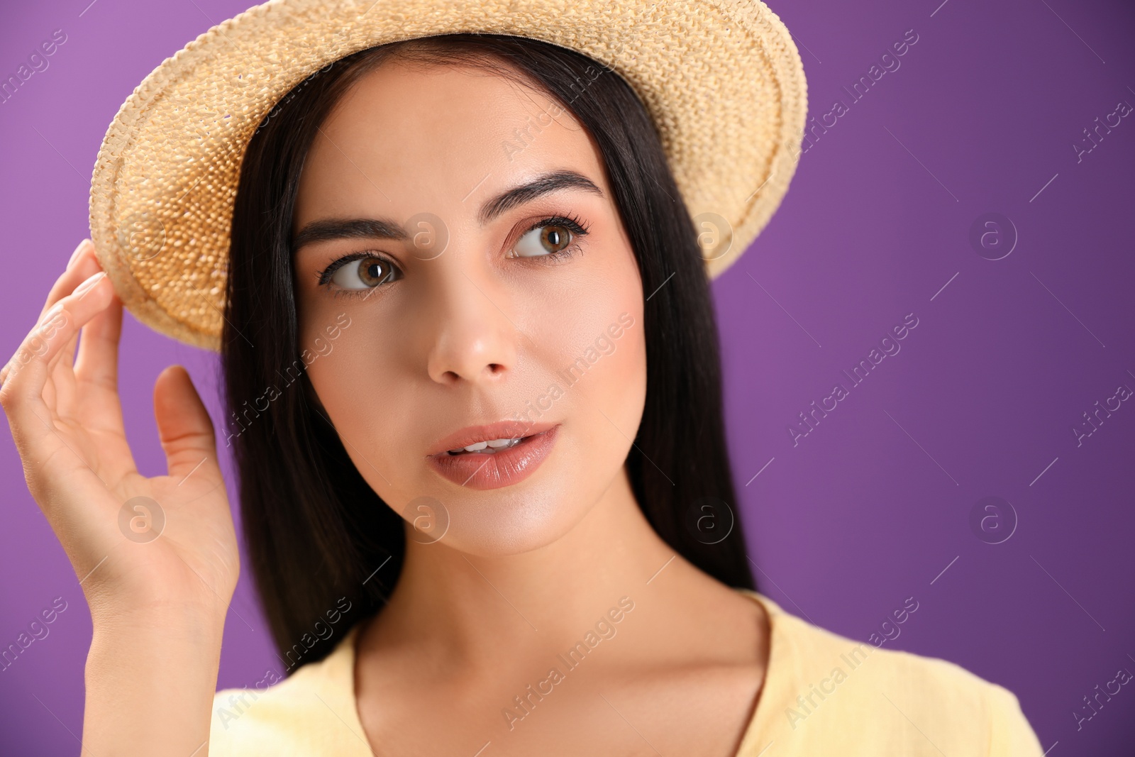 Photo of Portrait of beautiful young woman on purple background