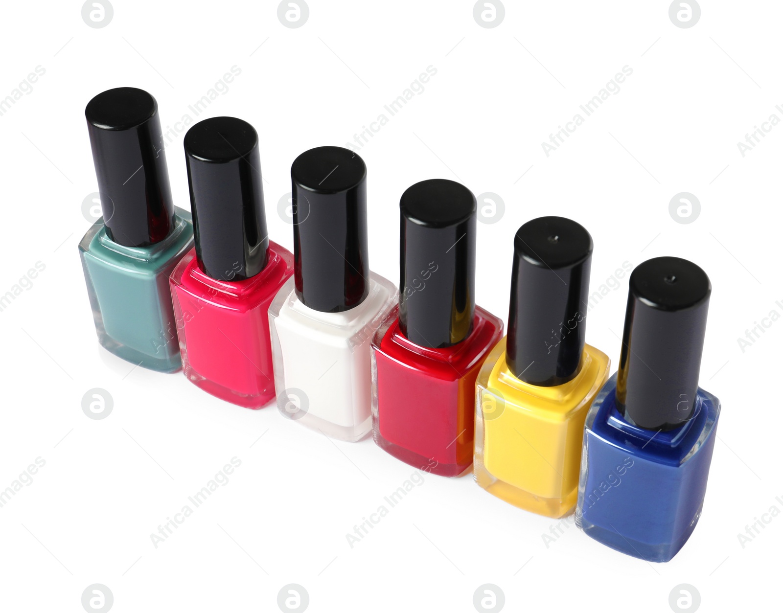 Photo of Bright nail polishes in bottles isolated on white