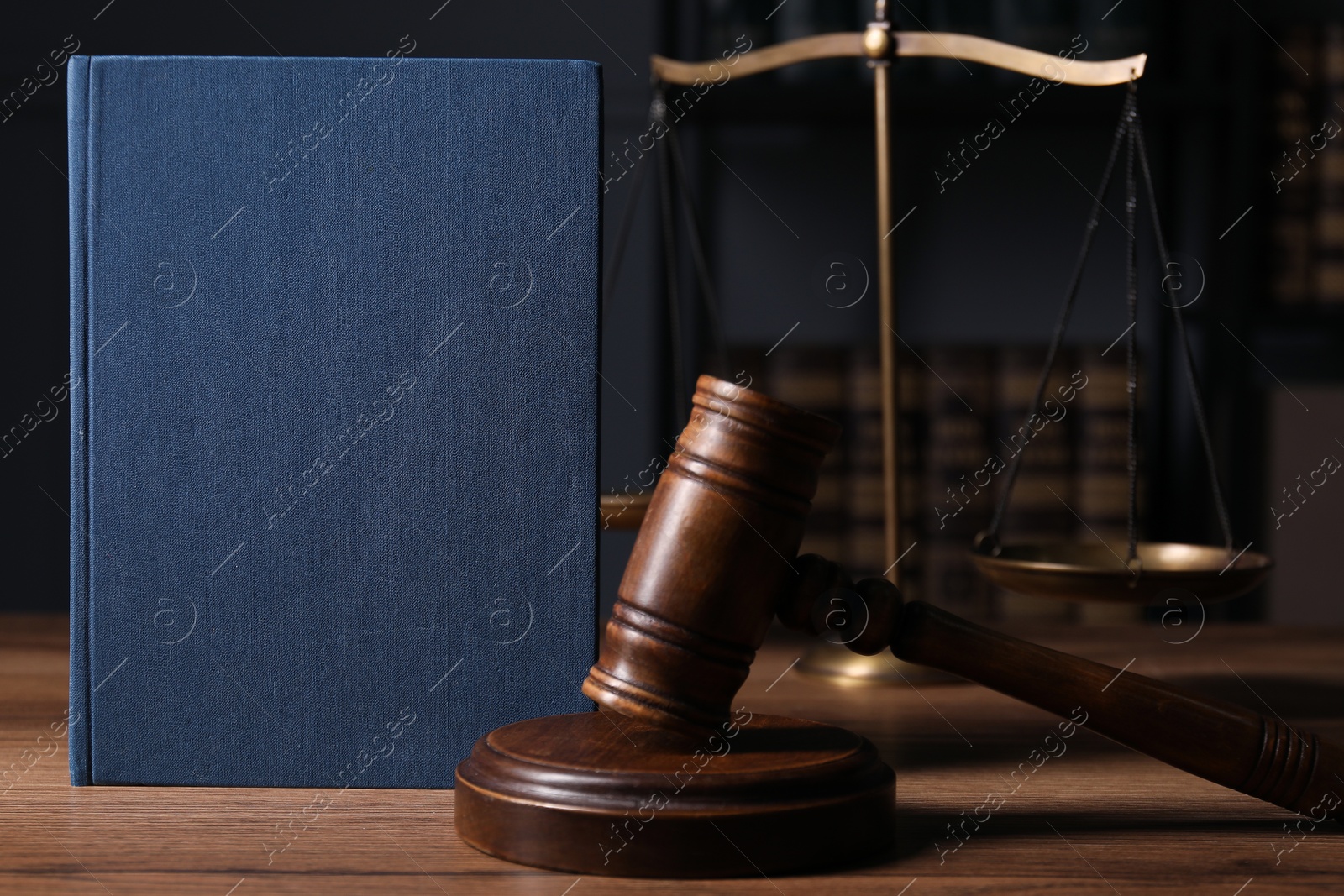 Photo of Law. Book, gavel and scales on wooden table