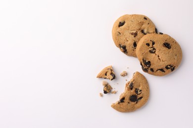 Photo of Delicious chocolate chip cookies on white background, flat lay. Space for text