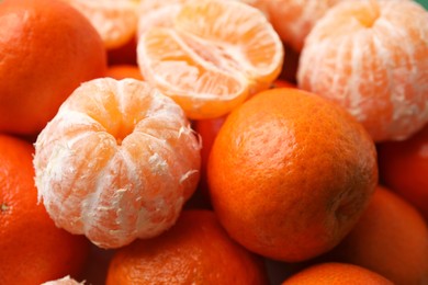 Many fresh ripe tangerines as background, closeup