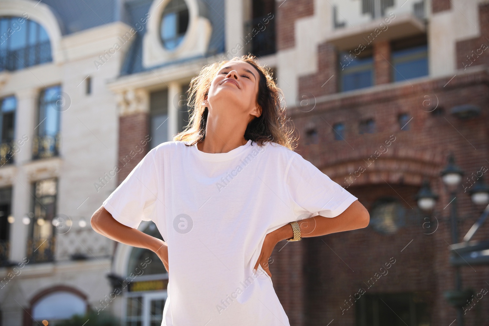 Photo of Portrait of happy young woman on city street