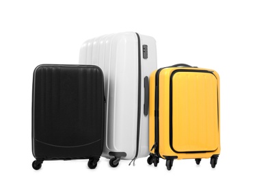 New suitcases packed for journey on white background