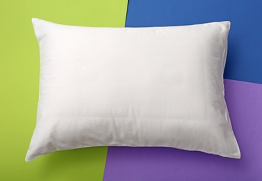 Photo of Soft bed pillow on color background, top view