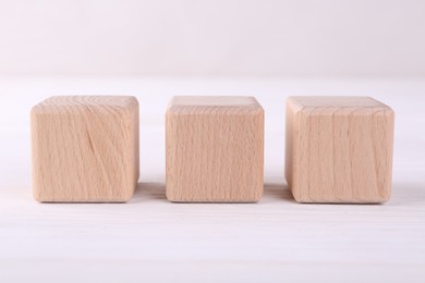 Photo of International Organization for Standardization. Wooden cubes with abbreviation ISO on white table, closeup
