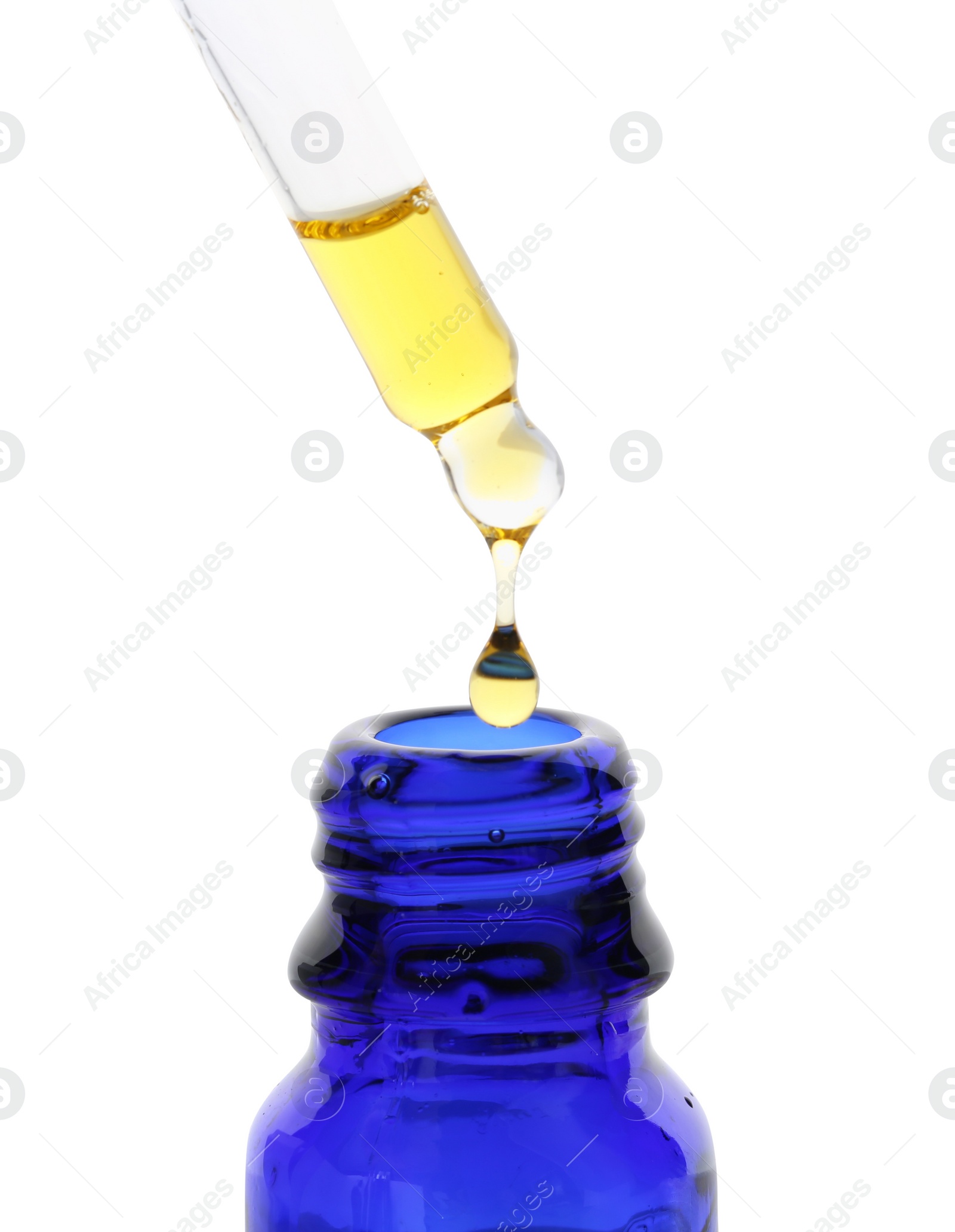 Photo of Dripping tincture from pipette into bottle isolated on white