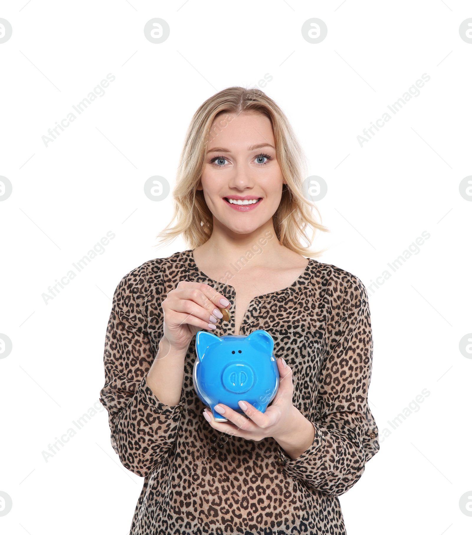 Photo of Beautiful young woman putting coin into piggy bank on white background