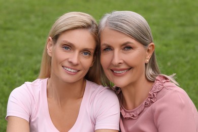 Happy mature mother and her daughter outdoors