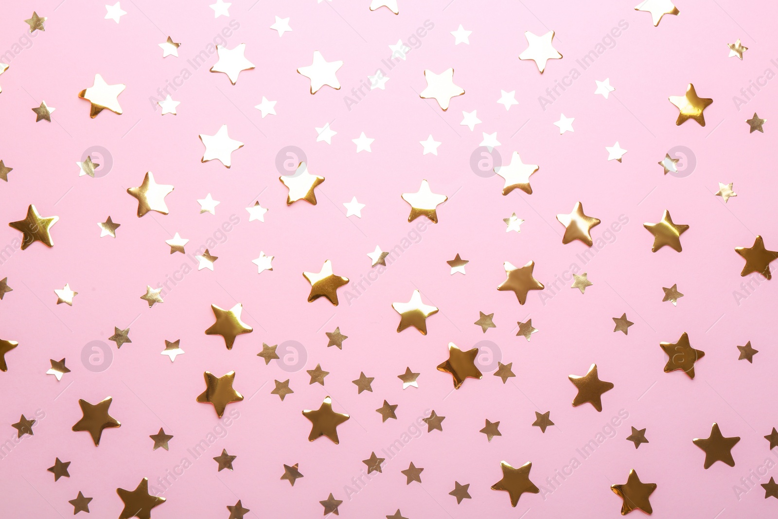 Photo of Confetti stars on pink background, flat lay. Christmas celebration