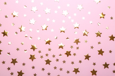 Photo of Confetti stars on pink background, flat lay. Christmas celebration