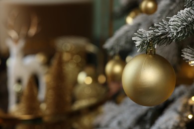 Beautiful decorated Christmas tree with baubles and lights on blurred background, closeup. Space for text