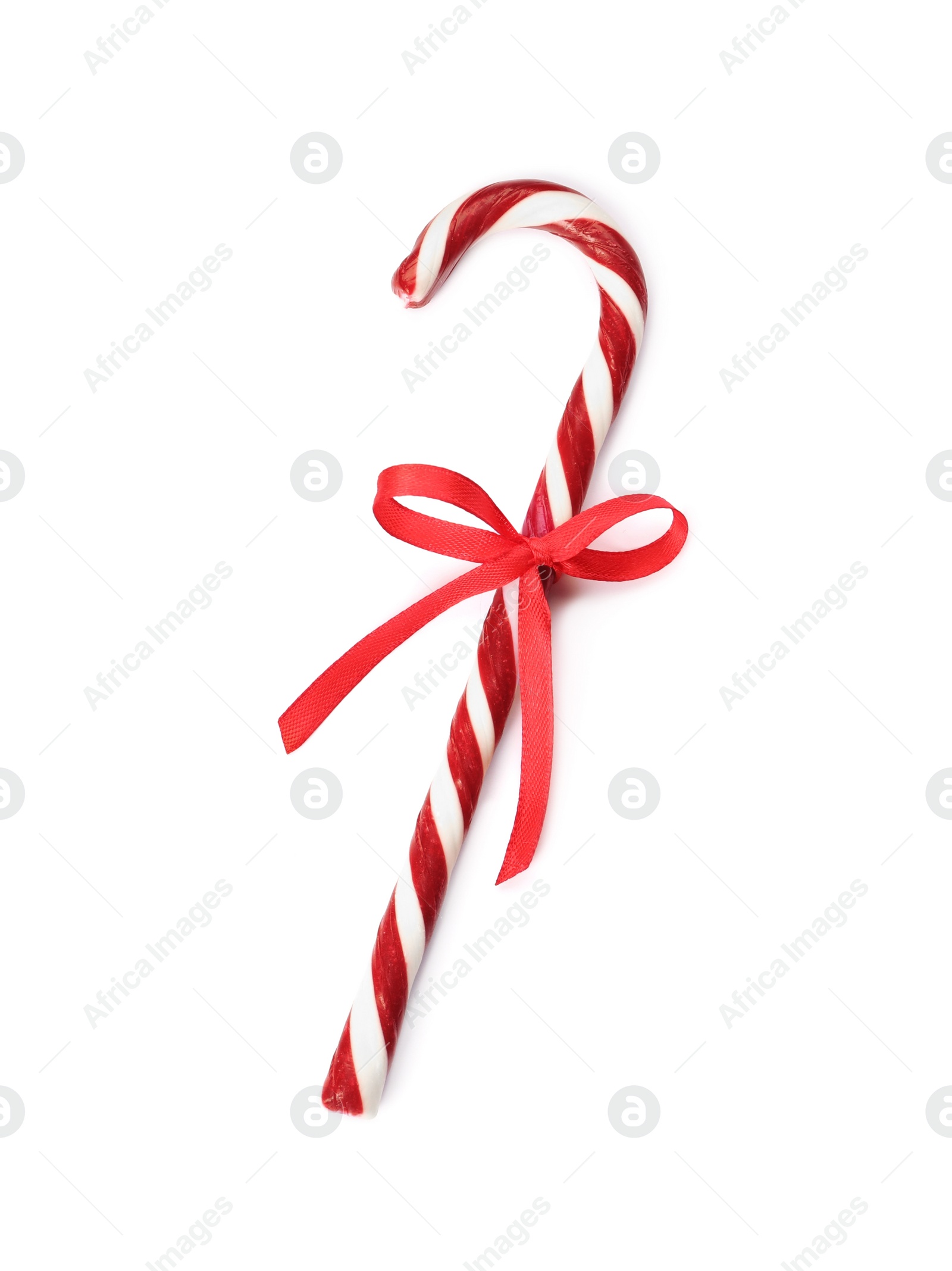 Photo of Delicious Christmas candy cane with red bow isolated on white, top view