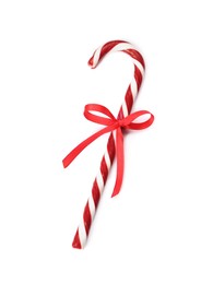 Photo of Delicious Christmas candy cane with red bow isolated on white, top view