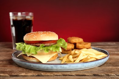 Photo of Delicious fast food menu on wooden table