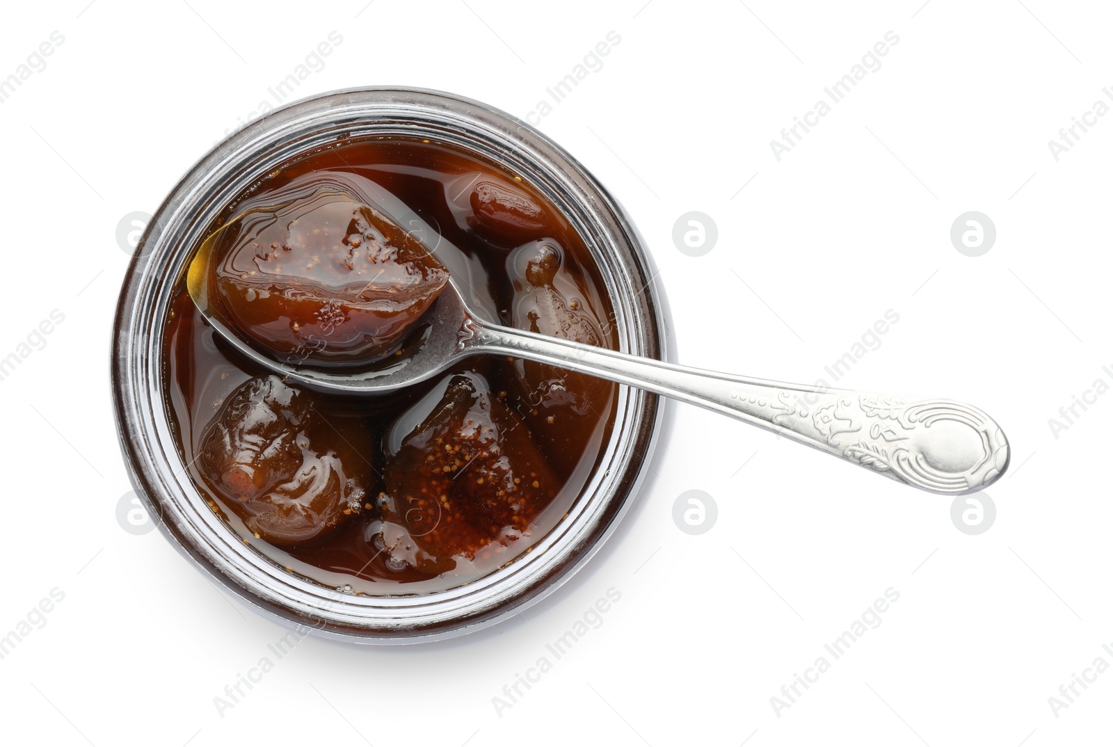 Photo of Jar of tasty sweet fig jam and spoon isolated on white, top view