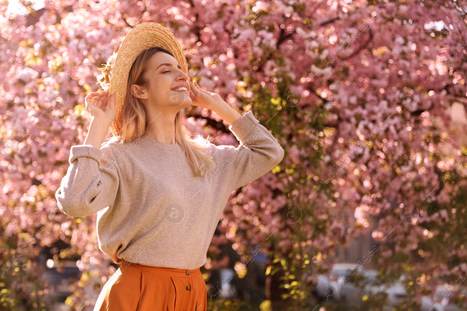 Photo of Young woman wearing stylish outfit in park on spring day. Fashionable look