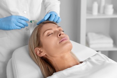 Trichologist giving injection to patient in clinic, closeup