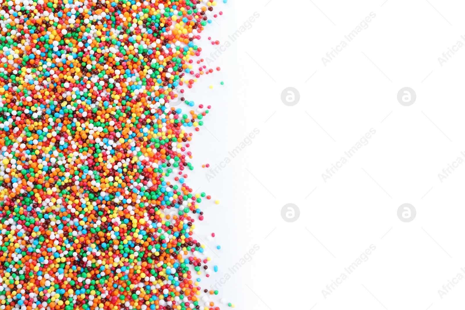 Photo of Colorful sprinkles on white background, top view. Confectionery decor