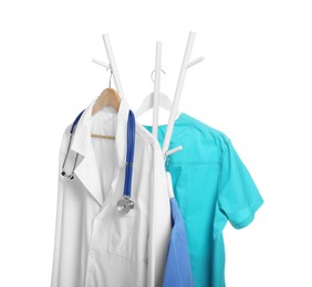 Photo of Doctor's gown with stethoscope and medical uniform on rack against white background