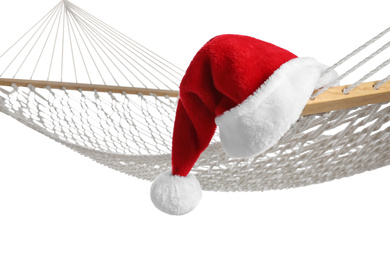 Comfortable hammock and Santa Claus hat on white background, closeup. Christmas vacation