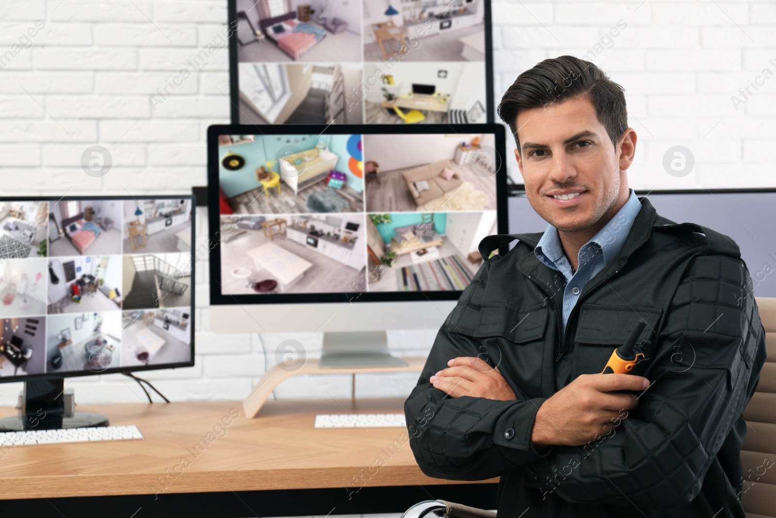 Photo of Male security guard with portable transmitter at workplace