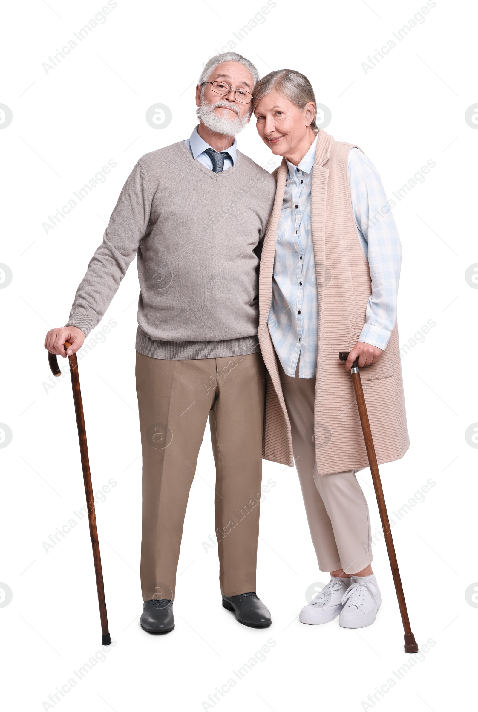 Photo of Senior man and woman with walking canes on white background