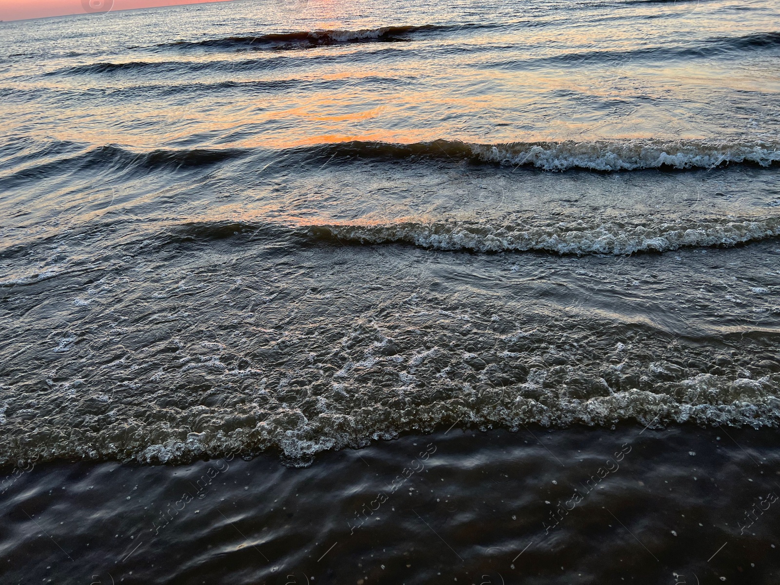 Photo of Beautiful view of sea waves at sunset