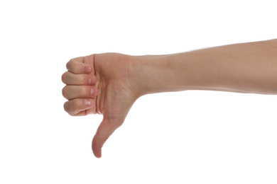 Photo of Man showing thumb down gesture against white background, closeup of hand