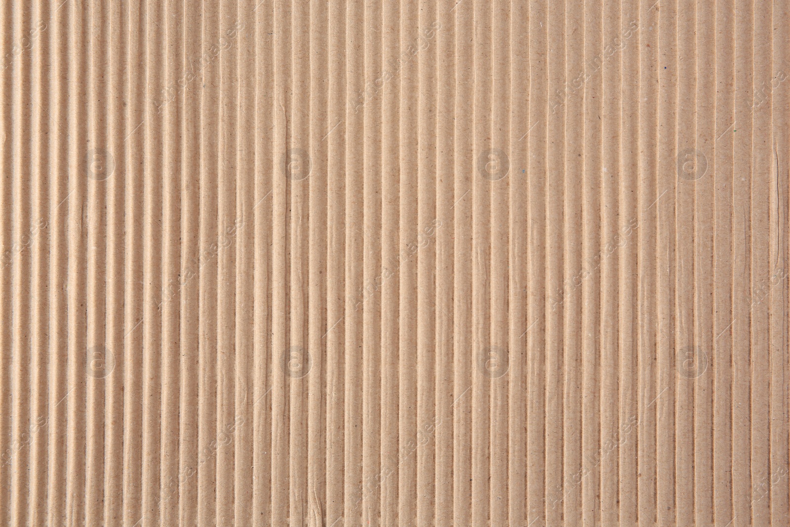 Photo of Texture of beige corrugated paper sheet as background, closeup